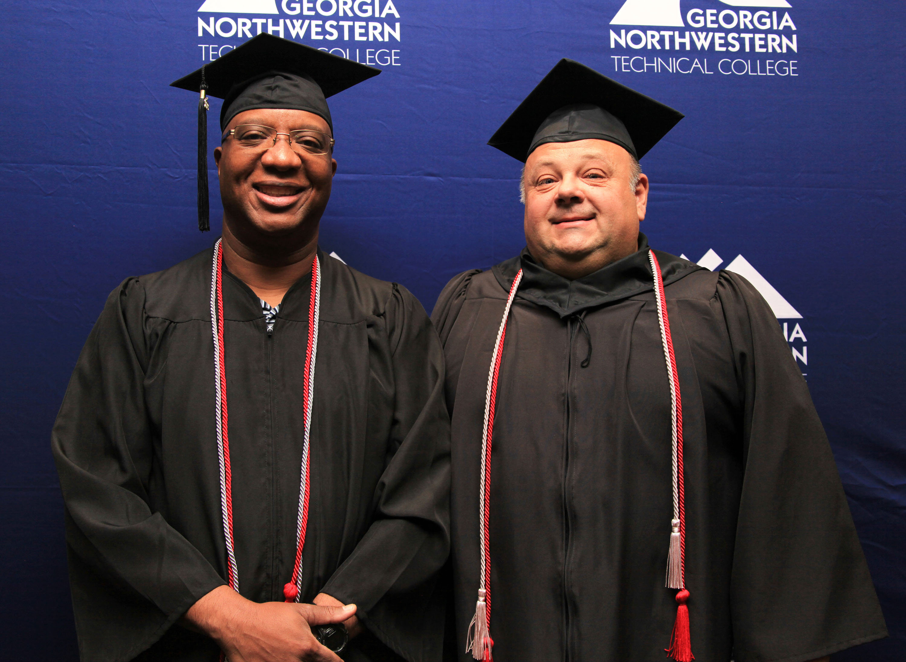 Scottie Carter, program director, assistant dean and instructor of Electrical Systems Technology at GNTC (right),congratulates graduate Ethron “Carl” Crawford at the Fall Commencement Ceremony.
