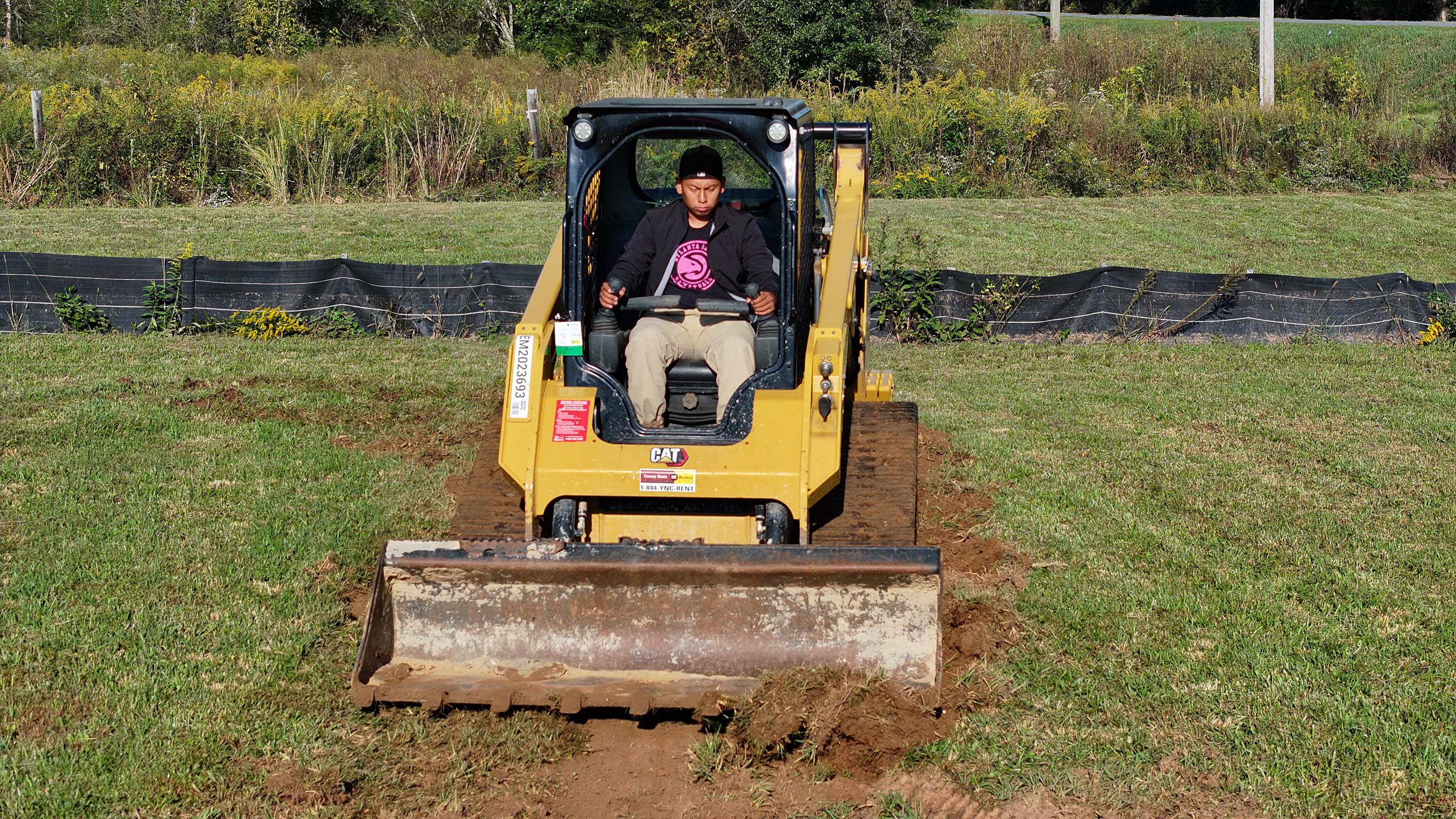 GNTC student Luis Garcia practices using a skid steer loader. 