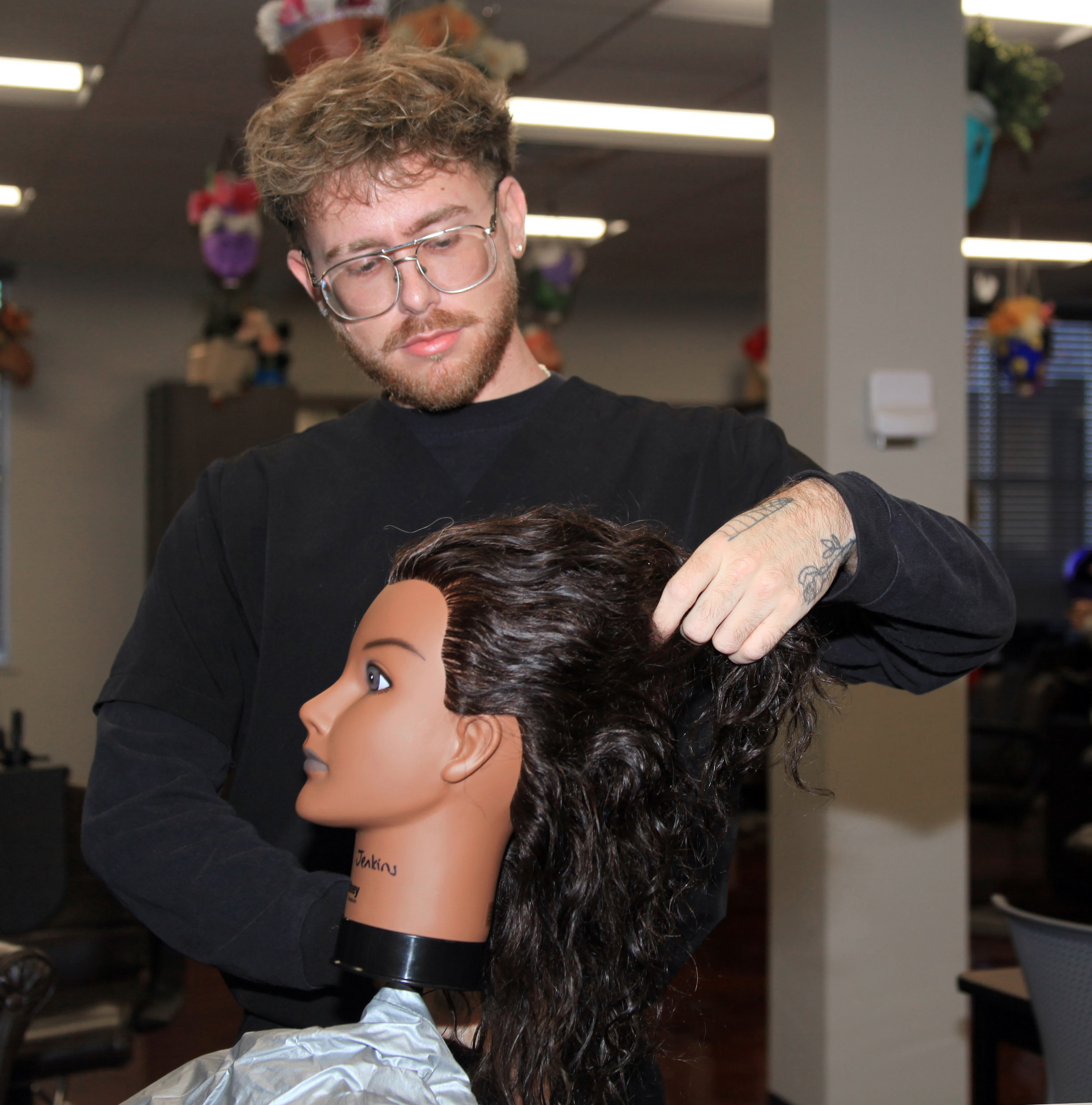 GNTC Cosmetology student Danny Jenkins practices styling hair.