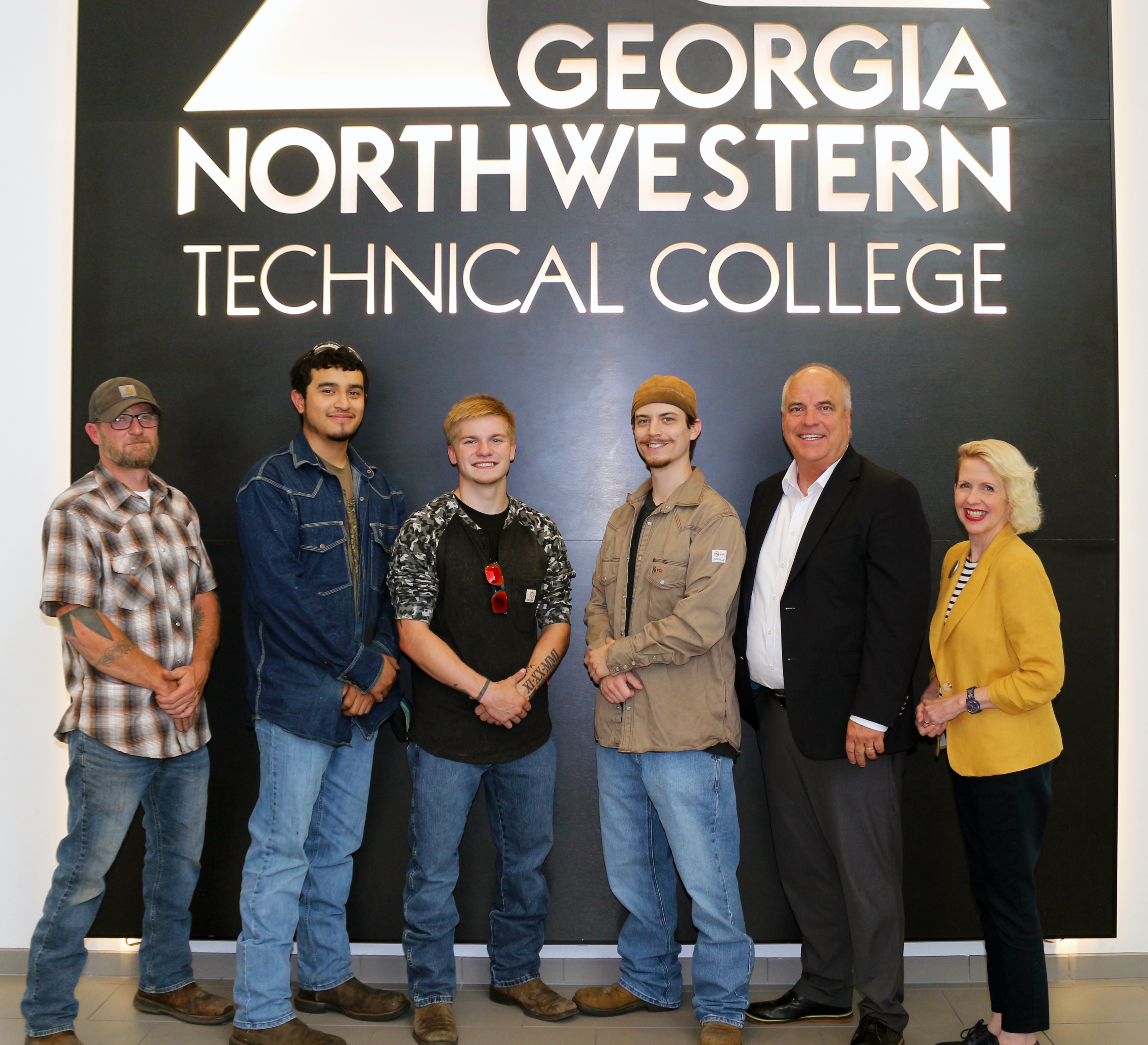 (From left) Billy Brown, GNTC Welding instructor; Angel Ramirez; Parker Shepherd; Conner Haynes; Russ DeLozier, president of The Carpet and Rug Institute; and Lauretta Hannon, executive director of Institutional Advancement at GNTC. Haynes, Ramirez and Shepherd are the fall 2024 recipients of The Governor Nathan Deal Technical Education Scholarship at GNTC.