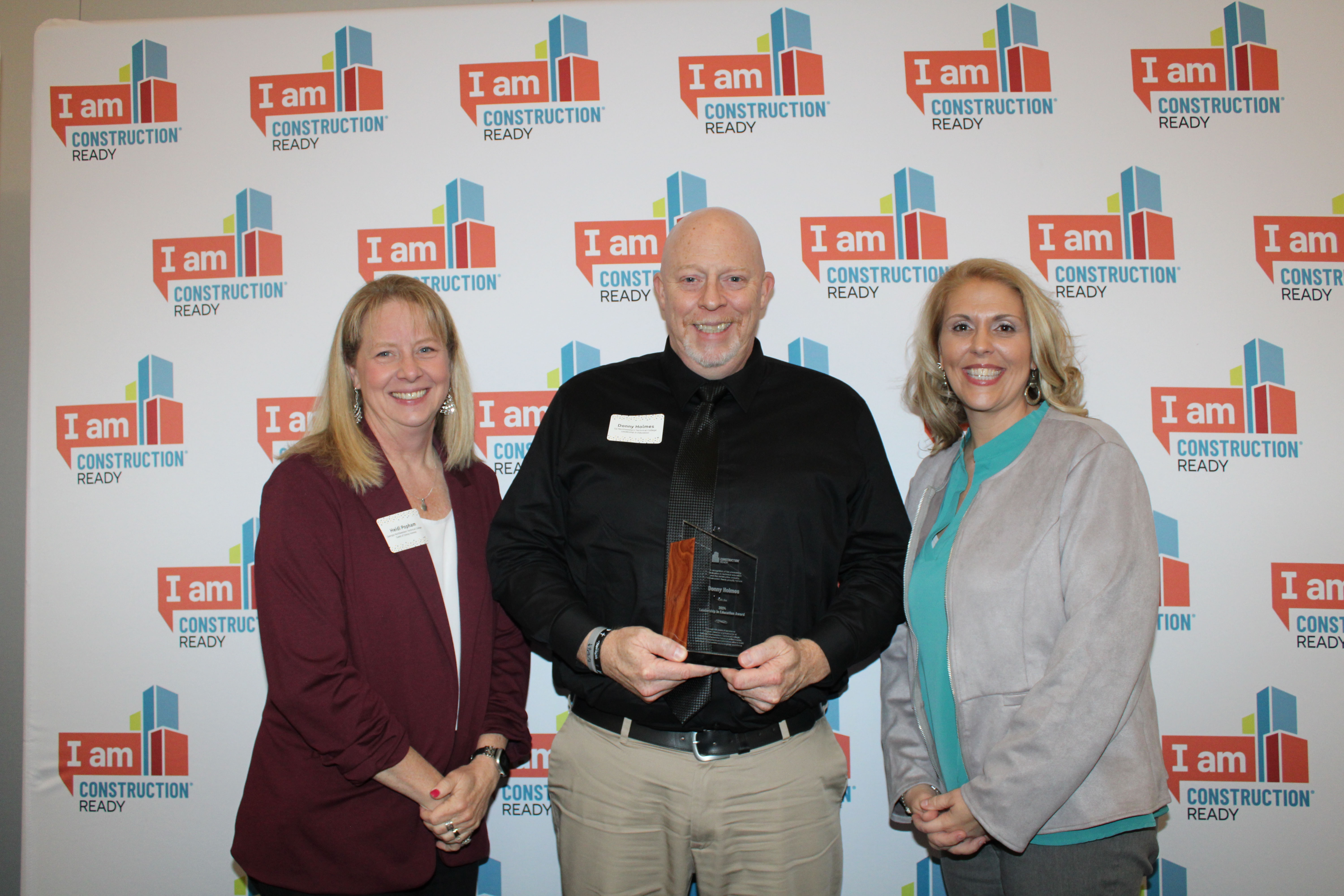 Donny Holmes, program director and instructor of Construction Management at GNTC (center), poses with Construction Ready’s Leadership in Education award with Dr. Heidi Popham, president at GNTC (left), and Dr. Elizabeth Anderson, vice president of Academic Affairs and Institutional Effectiveness at GNTC.