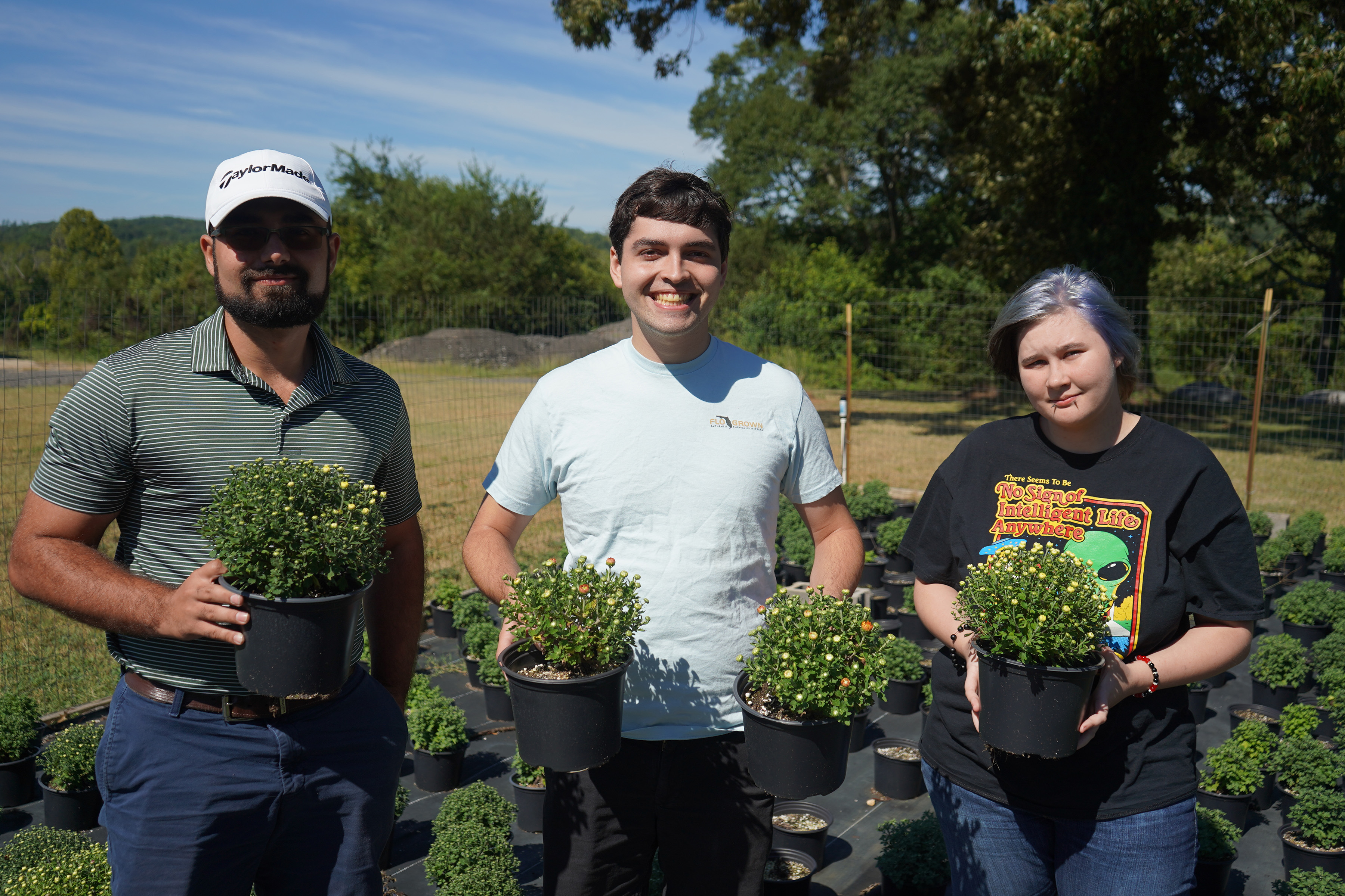 Horticulture students (from left) Joseph Cerniglia of Rome, Christian Simon of Rome and Catelynn Moon of Aragon pose with the mums that will be on sale during Georgia Northwestern Technical College’s Fall Mum Sale, Sept. 16-19.