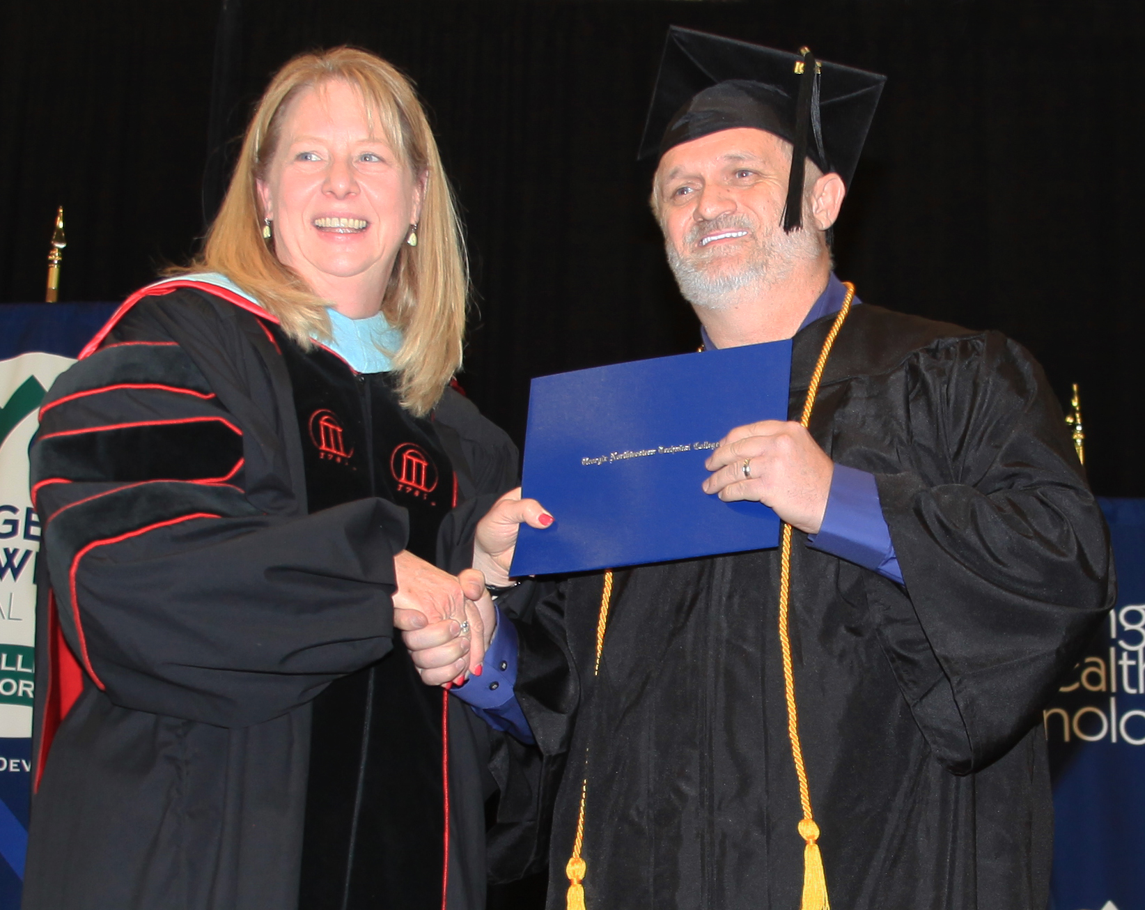 (From left) Dr. Heidi Popham, GNTC president, presents Tony Lamar Brooks with a diploma in Business Management.