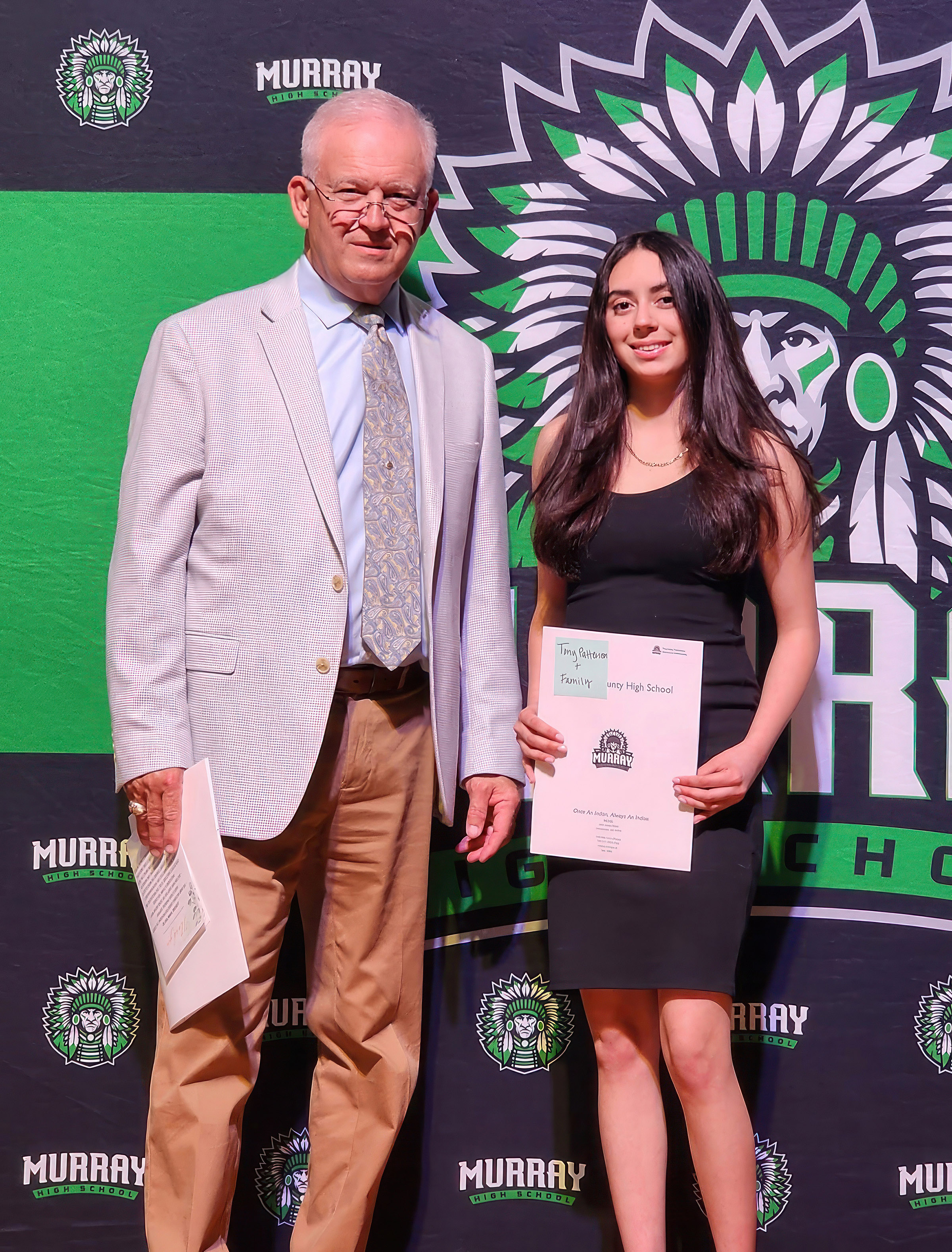 Tony Patterson (left) presents a Kirby Patterson Memorial Scholarship to Lisetty Garcia, a Murray County High School graduate.