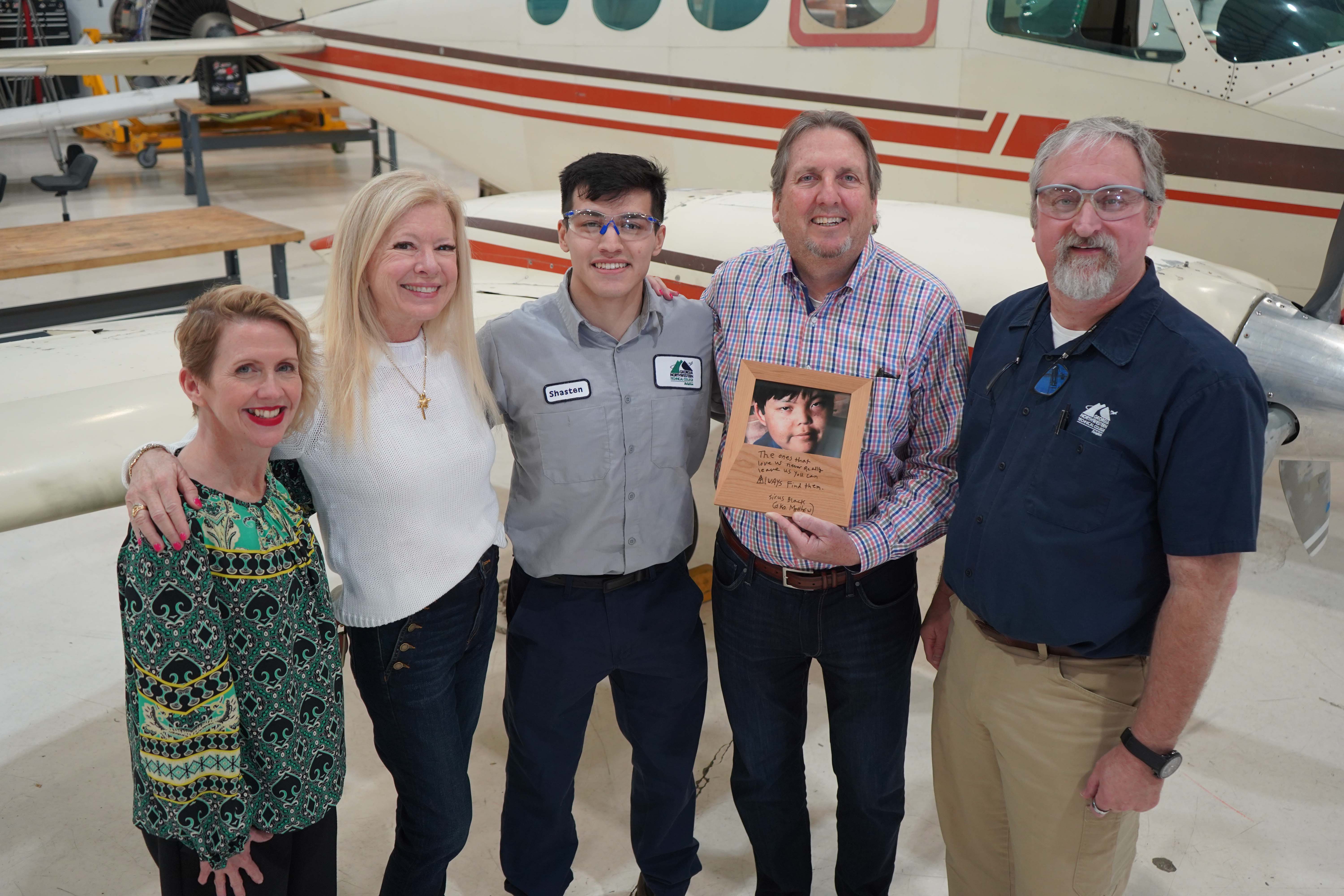 (From left) Lauretta Hannon, executive director of Institutional Advancement at GNTC; Kathi Vroman; scholarship recipient Shasten Tomas; Tim Vroman, who is holding a photo of GNTC Aviation Maintenance Technology graduate Matthew Vroman; and Jon Byrd, executive director of Aviation at GNTC and Technical College System of Georgia (TCSG) state aviation advisor, celebrate the award of the first Matthew Vroman Memorial Scholarship.